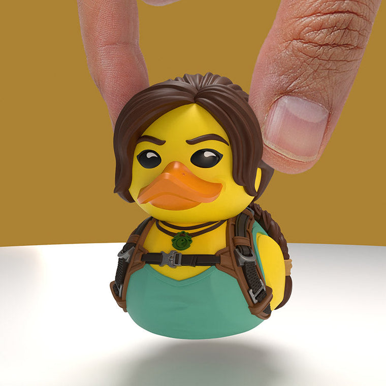 Tomb Raider Lara Croft 30th Anniversary TUBBZ Mini Edition collectible duck, held between finger and thumb to show its size