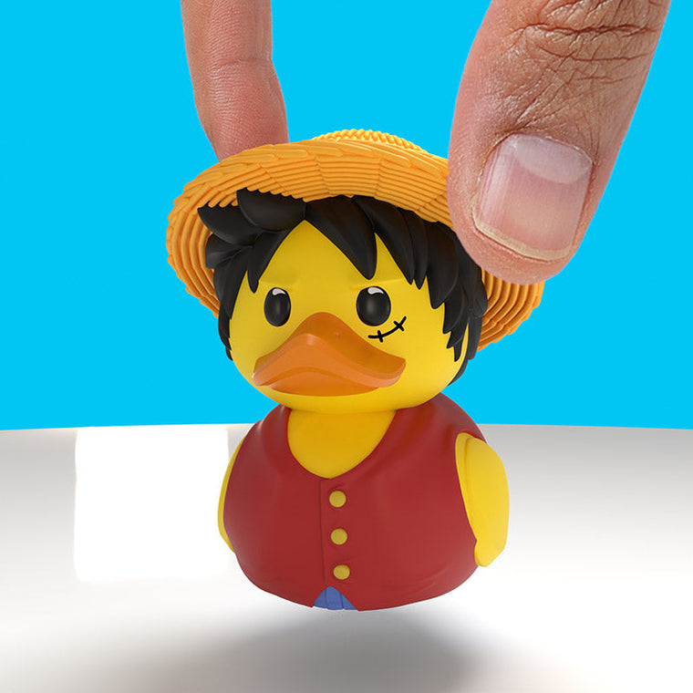 One Piece Monkey D. Luffy Mini TUBBZ, held between finger and thumb to show its small size