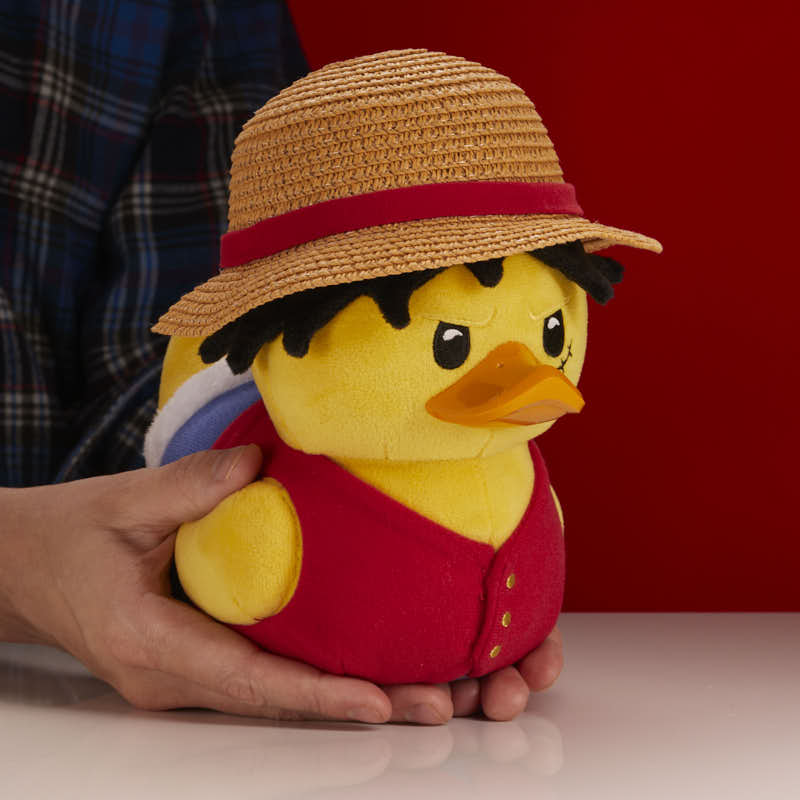 One Piece Monkey D. Luffy TUBBZ plush duck, held in two hands to show its soft plush size