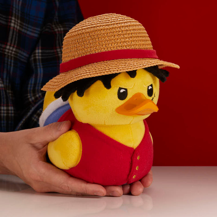 One Piece Monkey D. Luffy TUBBZ plush duck, held in two hands to show its soft plush size