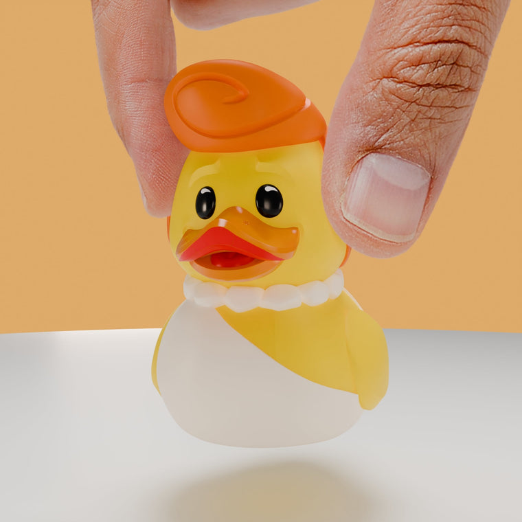 The Flintstones Wilma Flintstone TUBBZ Mini Edition collectible duck, held between finger and thumb to show its size